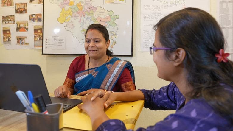 Two colleagues working together at the Daira project office