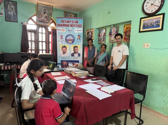 A Jiveesha screening camp, clinicians working with children on laptops